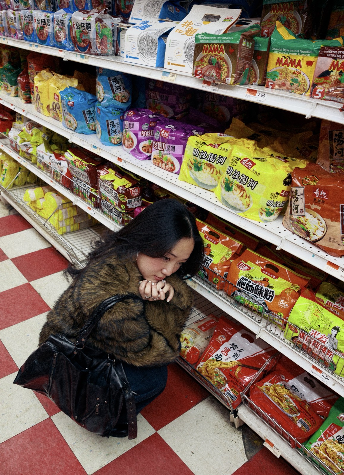 Crouched among snack shelves