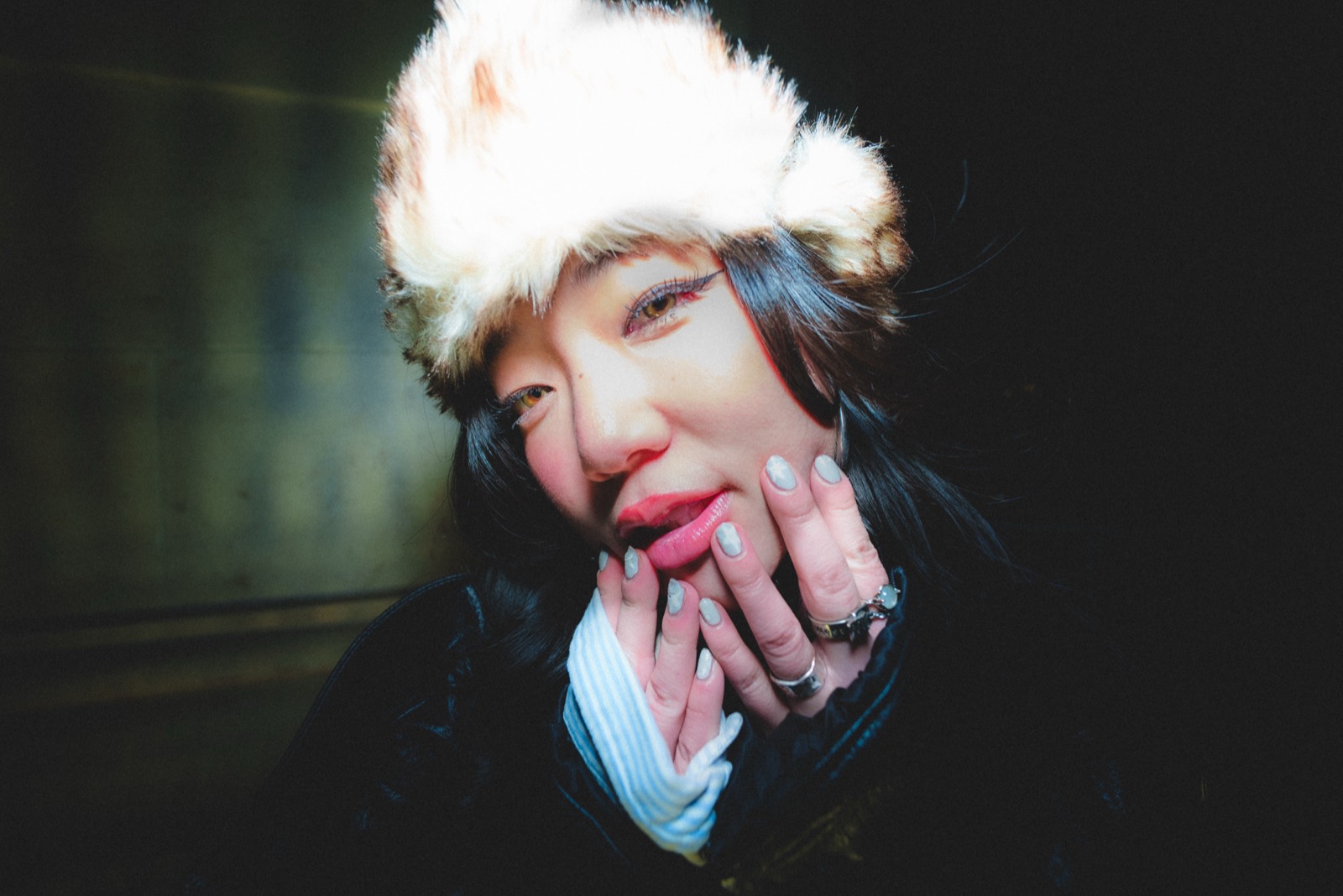 Night flash, hands at face