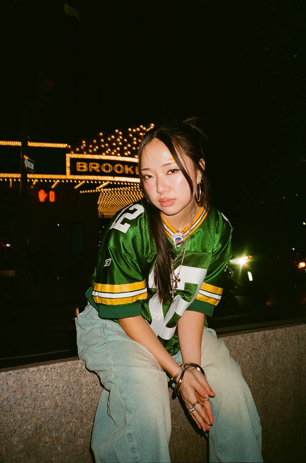 Yoonji in a green jersey at night