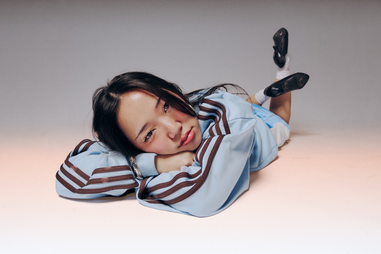 Lying down, chin on arms