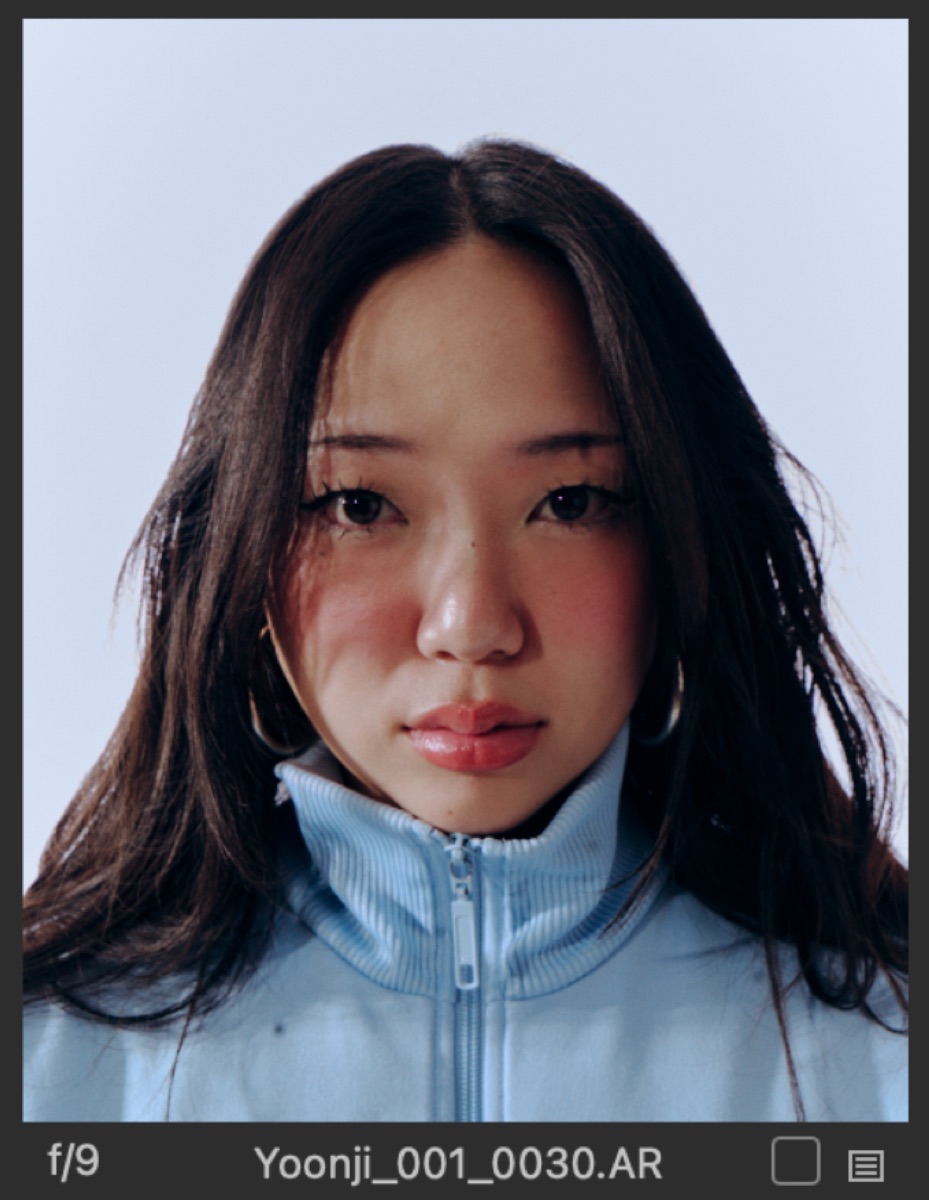Yoonji portrait in a light blue track jacket